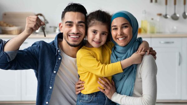 Happy Middle Eastern Family With Little Daughter Holding Home Keys