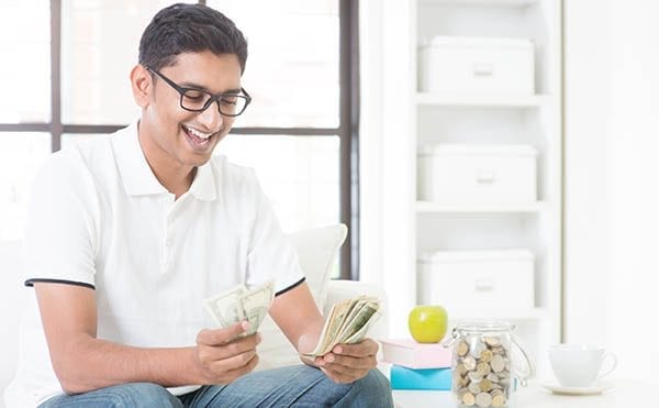 smiling-man-with-cash-in-hand