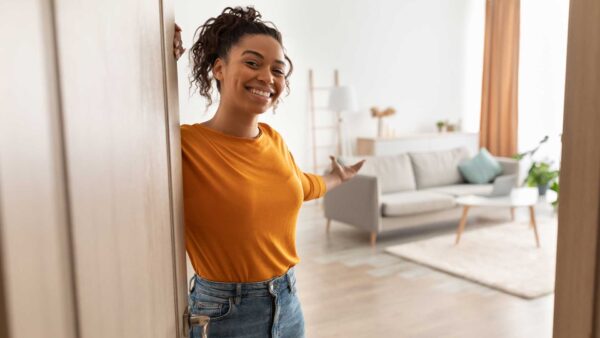 Cheerful Woman Opening Door