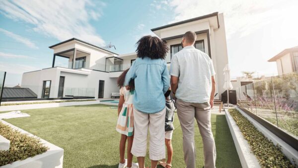 Family in their backyard together looking at their property