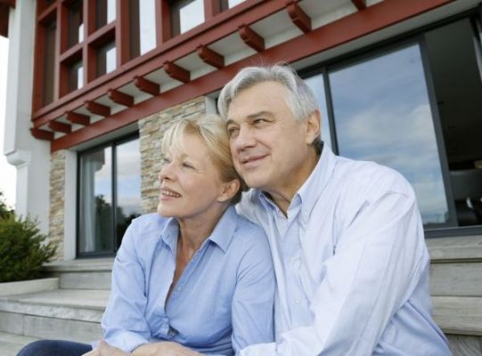 older-couple-sitting-outside-house