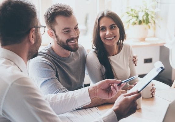 happy-couple-discussing-seller-paid-closing-costs-with-loan-officer